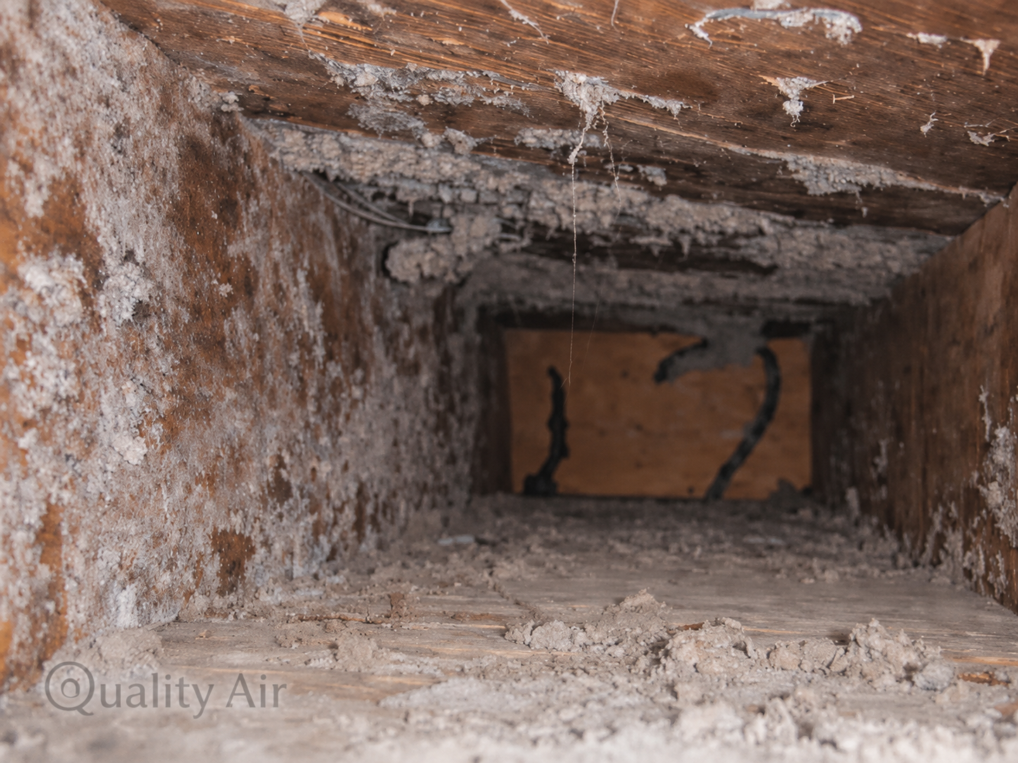 Dust and debris buildup inside an air duct before cleaning