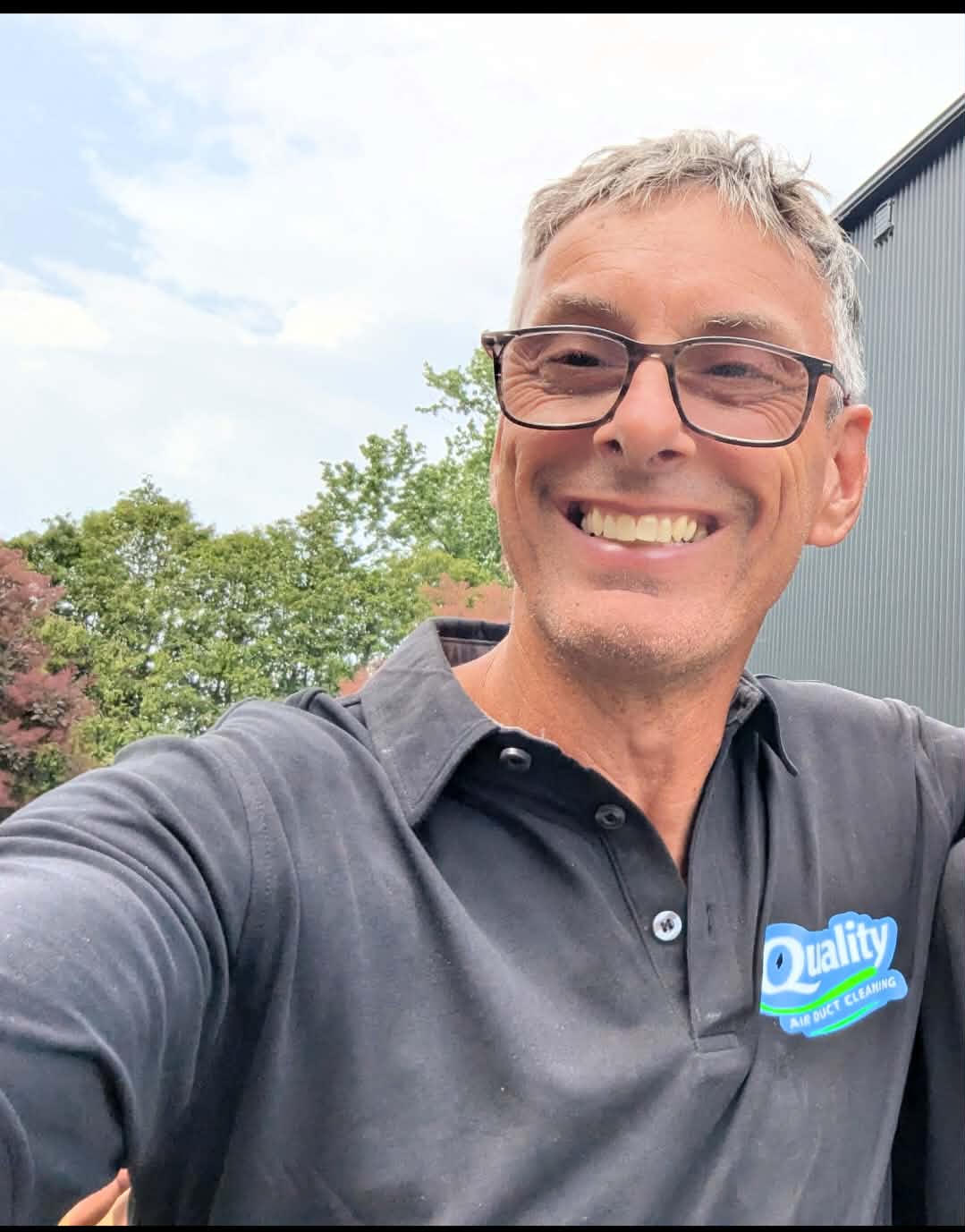 Tony Davis from Quality Air Duct Cleaning smiling in a Quality Air shirt